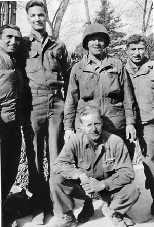 Towering above several of the sergeants he found alongside in the Colmar Pocket, the 6-3 Michael Daly grins during a brief respite from bitter combat during the waning days of the Third Reich.