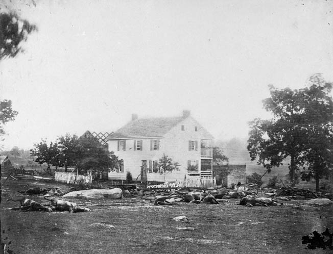 Dead horses belonging to Captain John Bigelow’s battery of Massachusetts Light Artillery litter the ground around the Trostle house at Gettysburg. Bigelow was wounded when his guns were overrun.