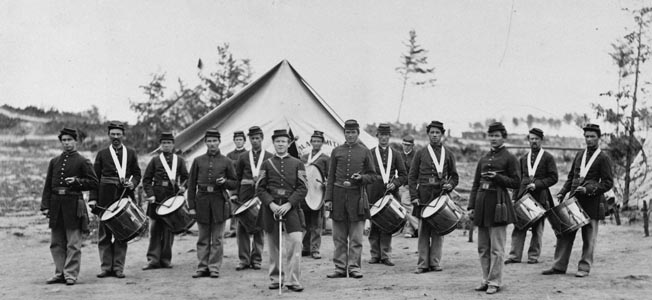 A sharply dressed group of fifers and drummers in the 30th Pennsylvania Infantry poses for the camera. The omnipresent music provoked some grumbling from the soldiers in the ranks.