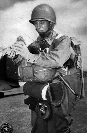 A paratrooper prepares to release a homing pigeon while on maneuvers during the U.S. Second Army’s Tennessee maneuvers, November 24, 1943.
