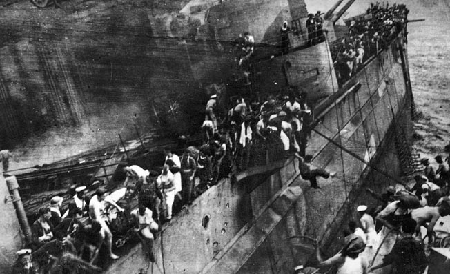 After being attacked by land-based Japanese planes, the crew of the battleship HMS Prince of Wales abandons ship near Kauntan in the South China Sea, December 10, 1941; 327 sailors perished.