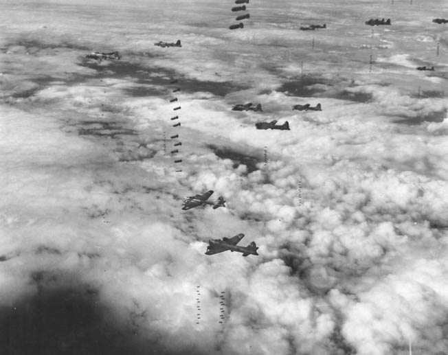 During a heavy raid on Magdeburg, Germany, in September 1944, Boeing B-17 bombers of the U.S. Eighth Air Force drop their sticks of bombs almost simultaneously as they brave flak and enemy fighters to remain on course for an accurate bomb drop. Magdeburg and other major German cities were well protected by the Luftwaffe in the air and by flak units on the ground.