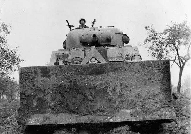 The bulldozer tank proved bulky and slow. Bromberg felt these tanks would only attract enemy fire in Normandy’s hedgerows. They were eventually replaced by Rhino tanks.