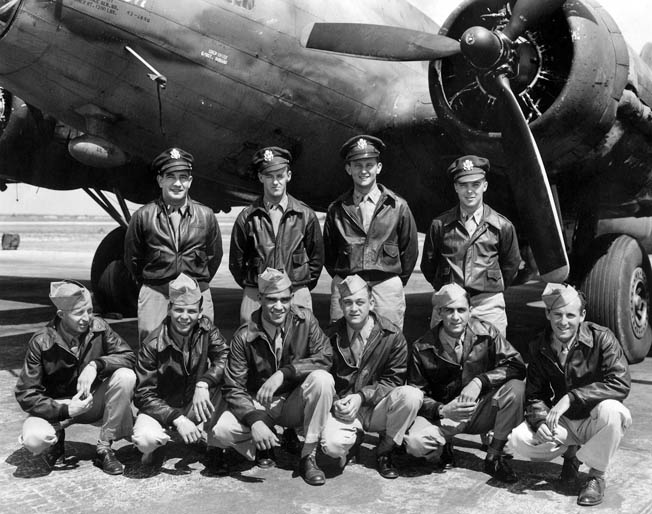 The crew of Full House, photographed in front of the plane. Stevens is in the front row, third from the left. 