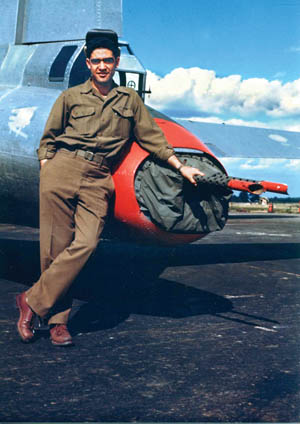 Larry Stevens poses at his tail-gunner’s position next to Full House. 