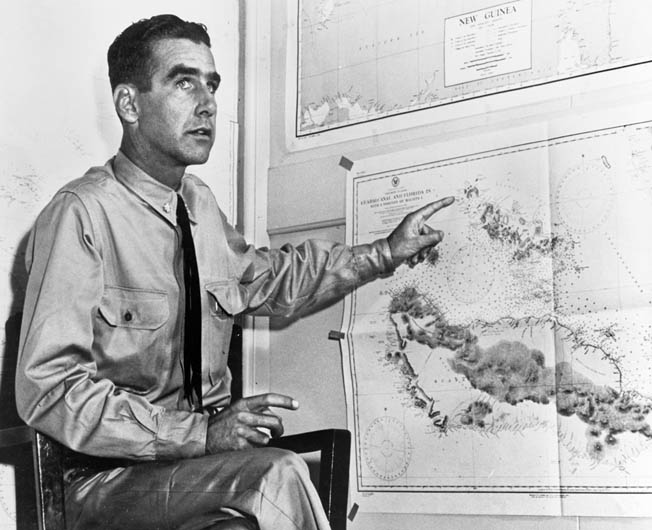 Lieutenant Commander Harry B. Heneberger, gunnery officer aboard the cruiser USS Quincy during the Battle of Savo Island, points to a map as he describes the abortive engagement after the battle had ended. 