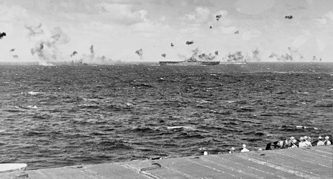 Antiaircraft shells explode as Japanese planes attack the Yorktown during an American raid on Kwajalein Atoll in the Marshall Islands, December 4, 1943. The Marshalls would be invaded by U.S. forces 11 months later.