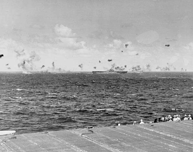 Antiaircraft shells explode as Japanese planes attack the Yorktown during an American raid on Kwajalein Atoll in the Marshall Islands, December 4, 1943. The Marshalls would be invaded by U.S. forces 11 months later.