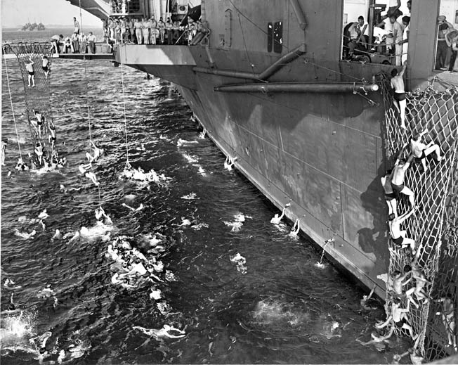 With a temporary lull in the fighting, crew members swim around the Yorktown in Majuro Lagoon, Marshall Islands, February 10, 1944. 