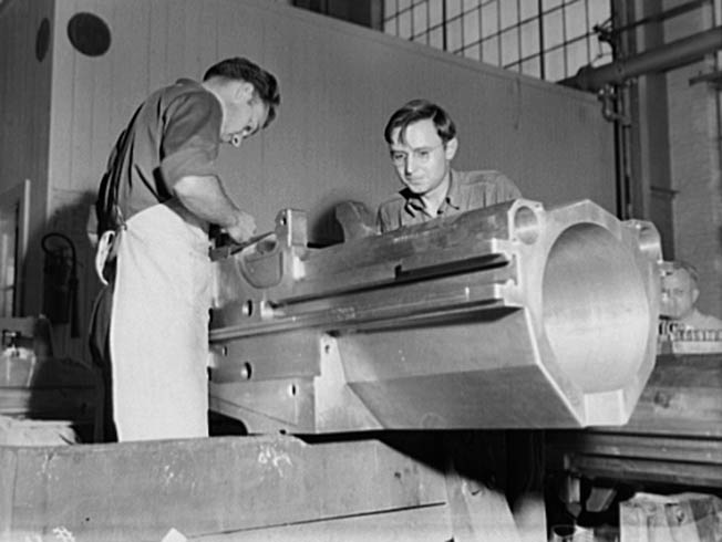 Workmen on the floor at the Watervliet Arsenal finish the breech housing for a medium caliber gun at the Watervliet Arsenal. Hundreds of workers were employed at the arsenal during the war years.