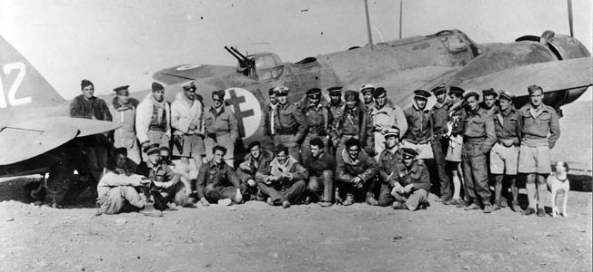 Standing in front of one of their aircraft, members of the Free French Air Force Lorraine Bomb Group exhibit esprit de corps in the North African desert. These airmen joined the British Royal Air Force in 1943 to continue the fight against the Germans.