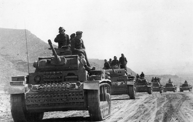 A column of German PzKpfw. III tanks rolls along a dirt road in North Africa. When American troops of the II Corps came up against the German veterans, the initial results were disastrous. The American commander, Maj. Gen. Lloyd Fredendall, was also found unequal to the task of leading troops in combat.