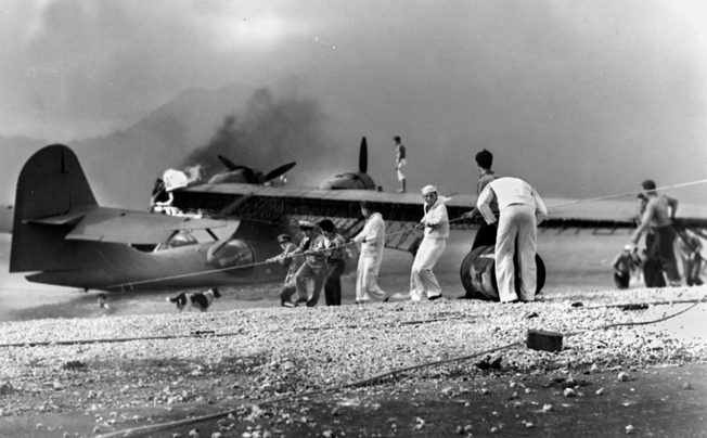 Sailors rush to save a burning PBY at Naval Air Station Kaneohe Bay. Construction work at the facility caught Takeo Yoshikawa’s attention, and he went to great effort to reconnoiter the facility for the Imperial Japanese Navy.