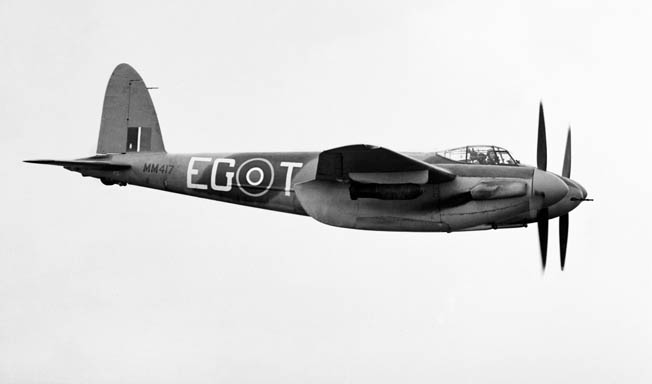 Carrying two 500-pound bombs under its wings, a Mosquito bomber of the Royal New Zealand Air Force is shown in flight in February 1944.