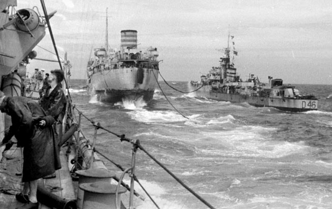 An auxiliary ship of Task Force 57 (center) refuels a British destroyer at sea. The Royal Navy struggled with logistics and resupply over the vast distances of the Pacific. 