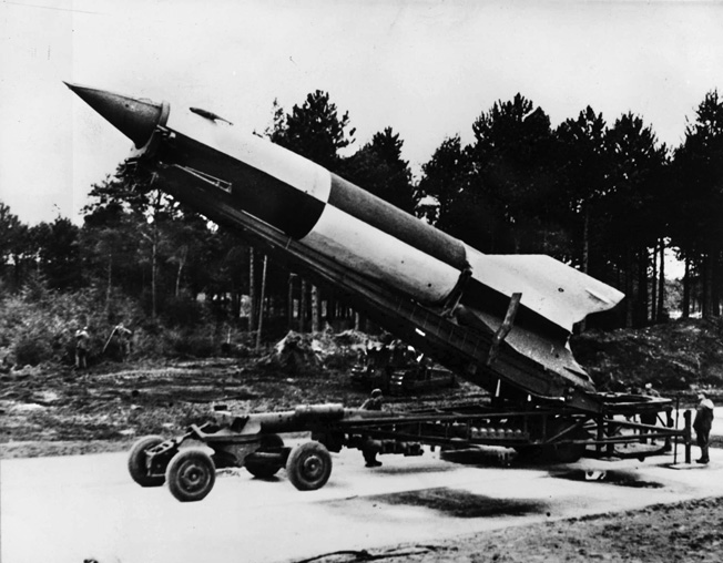 A German V-2 rocket is raised into launching position at Cuxhaven in the Luneburg District of Lower Saxony. 