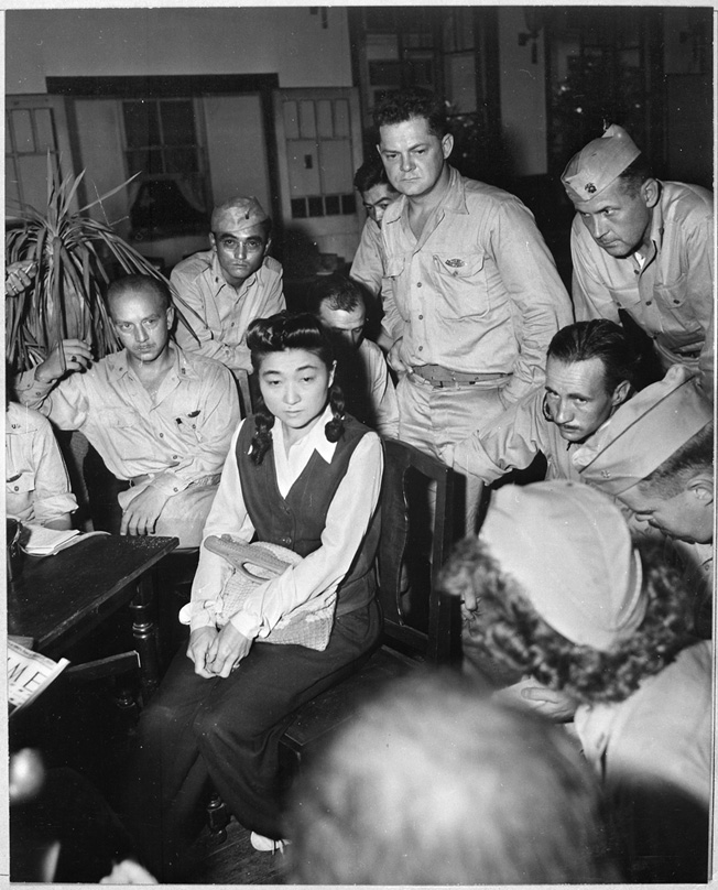 Military reporters interview Iva Toguri, an American citizen who made radio broadcasts for Japan, September 1945. 