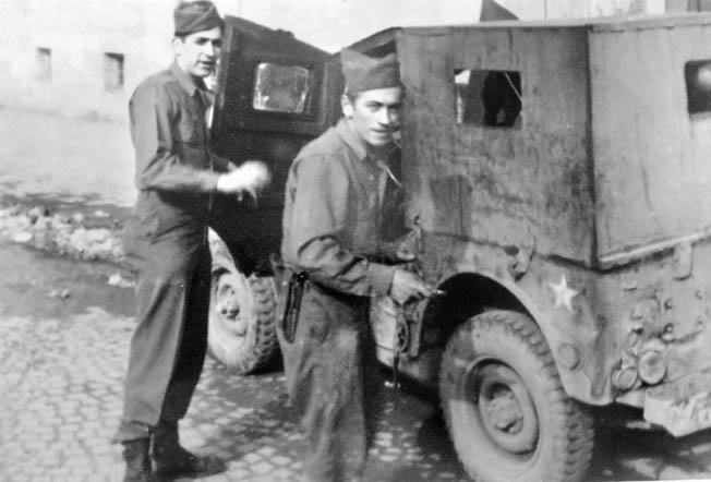 Leon Tulper (left) stands with his driver outside their radio jeep somewhere in Germany. 