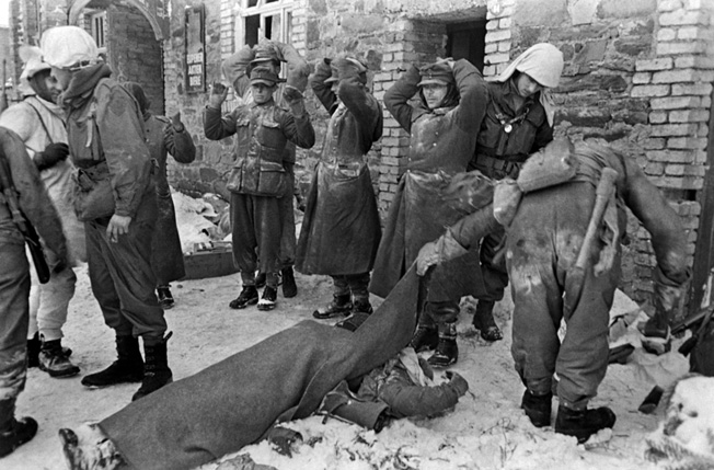 Soldiers of the 99th Infantry Division search German prisoners during the Battle of the Bulge. As word of German atrocities spread, American soldiers took fewer prisoners during the desperate fighting. The three drunk Germans that Sergeant Walter's men captured may not have reached a prison camp.