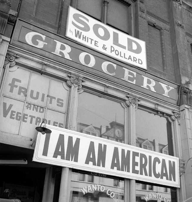 Despite a sign proclaiming his loyalty to the U.S., the Japanese American owner of this Oakland, California, grocery store was forced by the government to sell his business and move to an internment camp farther inland. 1942 photo by Dorothea Lange. 