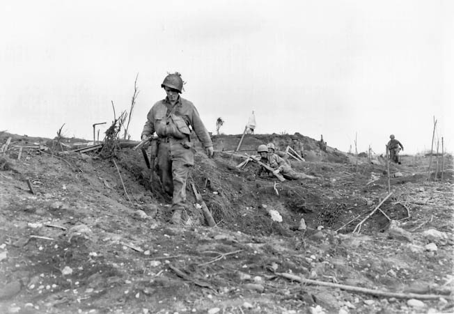 Men of Company I, 23rd Infantry, 2nd Infantry Division advance across an open area near Brest, August 29, 1944. Many GIs were killed or wounded when Germans blew up their own bunkers to prevent capture.