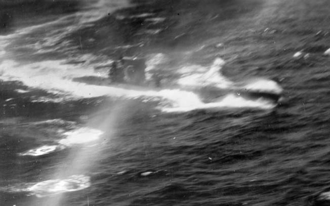 Forced to the surface by depth charges, a German U-boat takes evasive action off the coast of Portugal in August 1943. The Consolidated B-24 Liberator that is mounting the attack is under the command of pilot William Pomeroy.