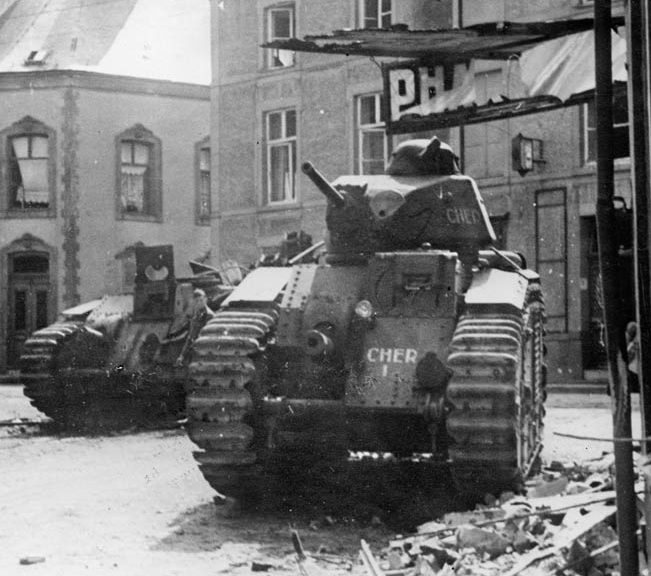  A pair of French tanks knocked out during the fighting to stem the German tide lie abandoned in a town square somewhere in Belgium.
