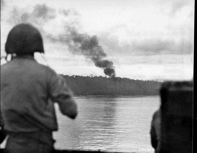 Smoke billows from the shells of the U.S. Navy destroyers Wilkes and Nicholson, providing close fire support for the American infantrymen fighting the Japanese onshore at Biak. This photo was taken on May 27, 1944, the day the U.S. troops landed on the island in the Schouten group near the western tip of New Guinea. 