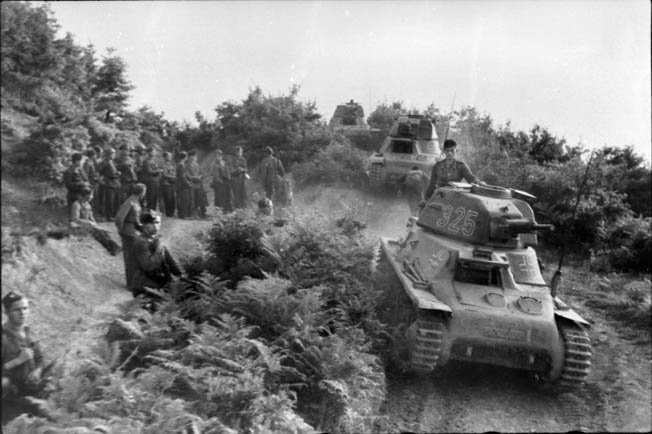 Tanks and troops of the German Army advance during the invasion of Yugoslavia. Among these German armored vehicles are three Hotchkiss tanks apparently captured during the invasion of France. 