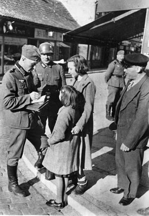 Life under Nazi rule was difficult for most Danes. Here, two Danish girls are stopped and questioned by German occupation troops. 