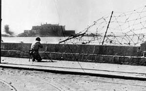 An American soldier views the stout, formidable walls of the Citadel at St. Malo. Surrounded on three sides by water, the medieval fortress held out for 11 days against fierce shelling and bombing.
