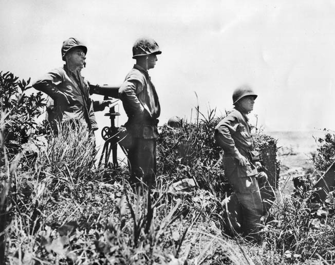 Commander of U.S. ground forces, Lt. Gen. Simon Bolivar Buckner, Jr. (right), surveys the battlefield in this photo taken just minutes before he was killed by an enemy shell, June 18, 1945. 