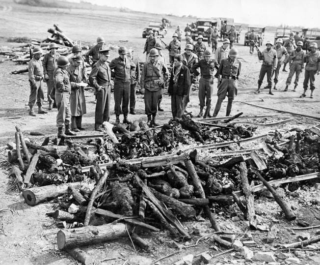 Generals Eisenhower, Bradley, and Patton view a pyre where corpses were burned at the Ohrdruf concentration camp, April 12, 1945. 