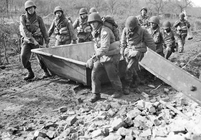 Combat engineers of the 84th Division drag assault boats to the banks of the Roer River on February 23, 1945. The final Allied push into Germany had begun.