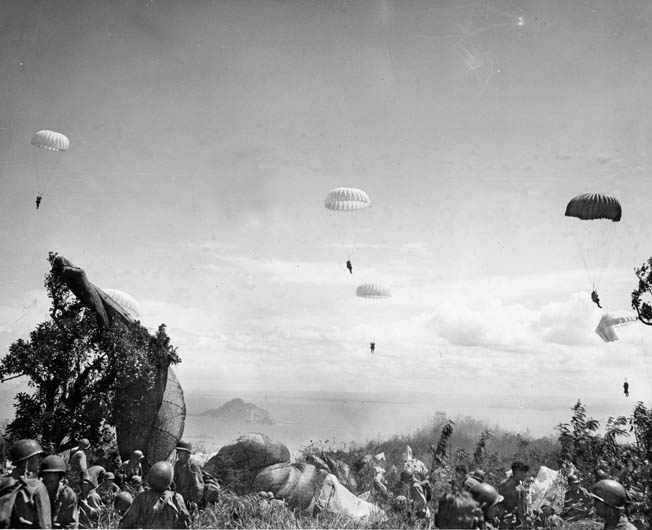 Their parachutes billowing in the sun, members of the 503rd Parachute Infantry Regimental Combat Team plummet toward the golf course on Corregidor. Planners recognized the hazards of the jump into a narrow area that was bounded by cliffs and the waters of Manila Bay.