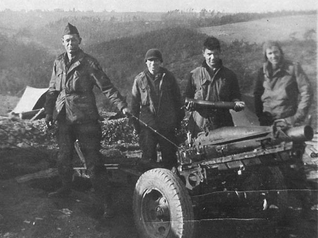 Sartain’s driver, Louis Sosa (second from left), and a glider artillery gun crew pose by a 75mm pack howitzer, Holland, October 1944. The gun was relatively light (1,439 pounds), easily transportable, and had a maximum range of approximately five miles.