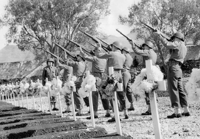 Lieutenant Craig commands the color guard in a 21-gun salute at the 2nd Armored Division cemetery on Armistice Day, November 11, 1943. Days after the ceremony, Craig would be sent home with torn knee ligaments.