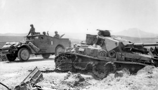 A scout car rolls past a knocked-out German Mark IV medium tank. Brig. Gen. Gay reprimanded Craig and wrote him a poor efficiency report when one of the vehicles in Craig’s caravan of two scout cars, a jeep, and a truck broke down. 