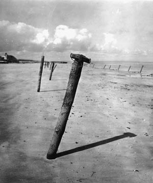 German antitank Teller mines, attached to posts buried in the sand at an angle, were planted liberally across the beaches of Normandy.