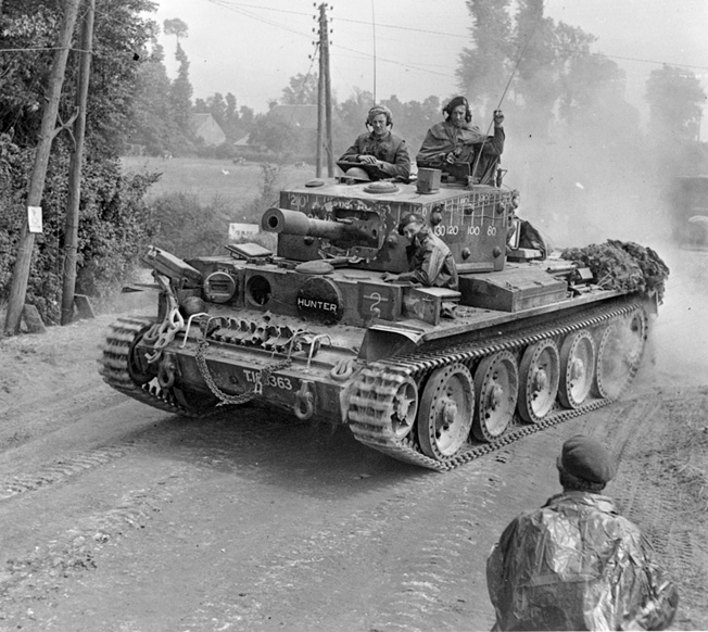 A British tank churns up a cloud of dust on the advance near Tilly-sur-Seulles on June 13, 1944. 