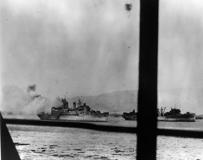 Smoke boils up from the USS Curtiss after the ship was struck by a crippled Japanese dive bomber during the attack on Pearl Harbor, December 7, 1941.