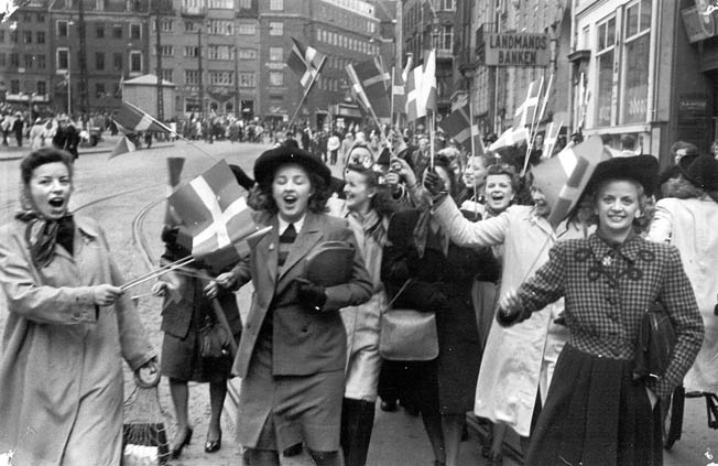 Copenhagen women joyously celebrate the liberation of Denmark, May 5, 1945. Nazi Germany surrendered three days later. 