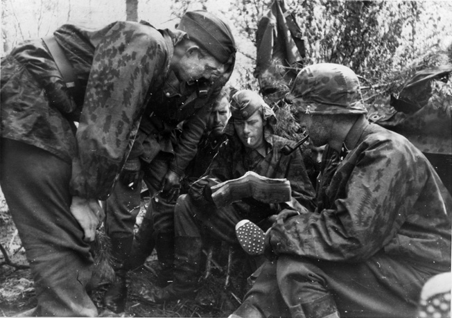 Men of Frikorps Danmark study a map, May-June 1942—about the time they lost two commanders. 