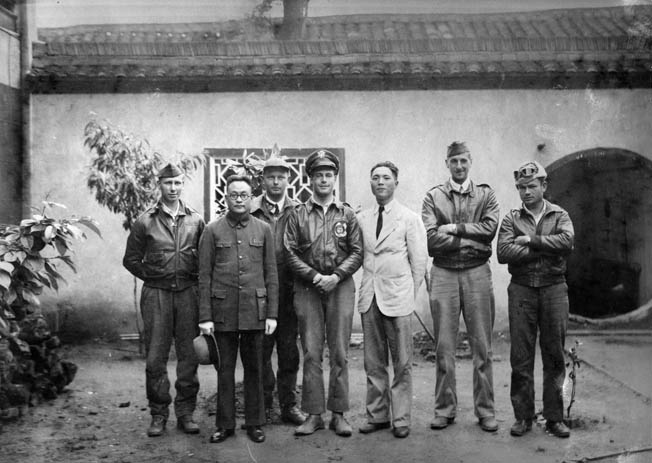 The crew of Lieutenant Travis Hoover’s Plane 2 pose with Tung-Sheng Liu, in white jacket, who helped the crew escape capture. Liu later immigrated to the United States and was named an honorary member of Doolittle’s Raiders. 