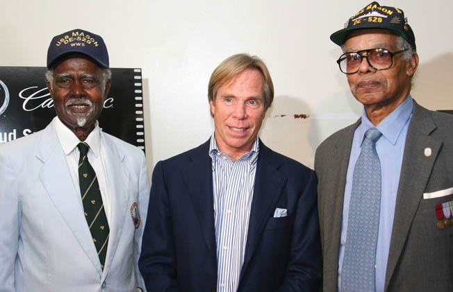 Petty Officer 2nd Class James W. Graham (left) and Petty Officer 1st Class Lorenzo A. DuFau, photo­graphed during the screening of the 2005 film Proud: The True Story of Men of Valor. Vice Admiral Samuel Lee Gravely, Jr. (right), who became the first African American admiral, served aboard PC-1264. 