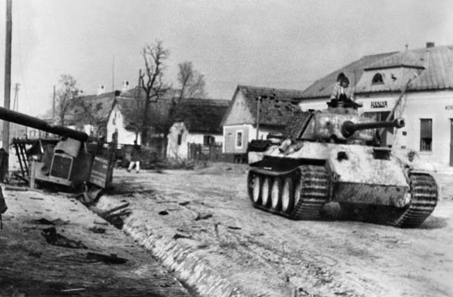 A German Panther in winter camouflage rumbles through a village during Operation Konrad in January 1945. Although badly mauled during the failed offensive to save Budapest from advancing Soviet forces, the IV Panzer Corps was sent into action again in Operation Spring Awakening.