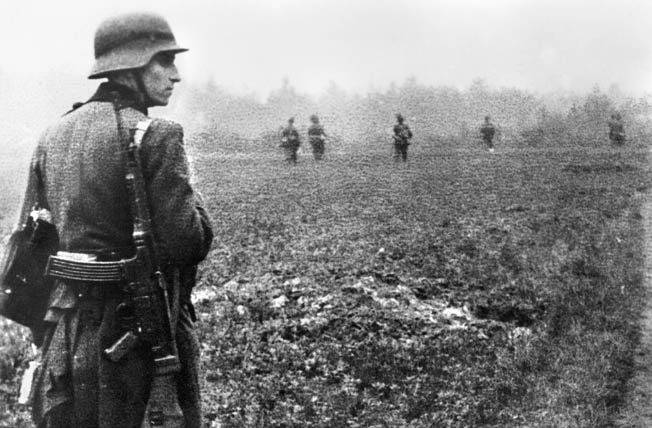 German infantry patrol a Dutch field in search of Allied airborne and glider troops. The soldier in the foreground is armed with a Sturmgewehr 44.