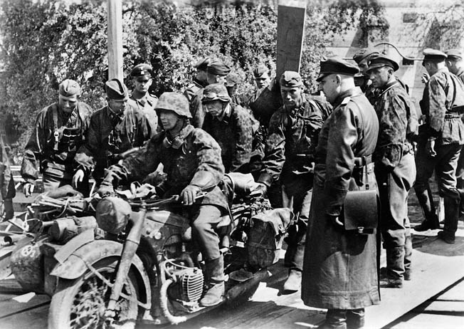 Riding motorcycles, soldiers of the German SS Division Das Reich pause during the assault on Belgrade. A small motorized detachment of Das Reich led by Captain Fritz Klingenberg captured Belgrade in an audacious and brilliantly executed advance.