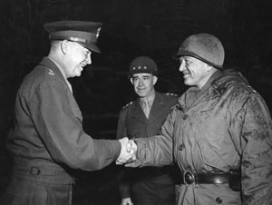 Eisenhower, left, confers with Bradley, center, and Patton,