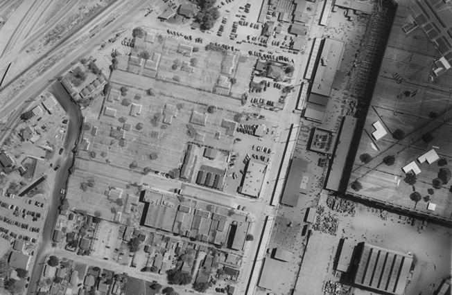 A bombardier’s-eye view. At first glance, it is hard to spot which areas of this aerial photograph of the Lockheed camouflage project in Burbank are real and which are fake. The area on the right is the main factory building (with ant-like humans seen as shadows) where thousands of aircraft were built below the faux village. Lockheed built 9,423 P-38 Lightnings in Burbank.